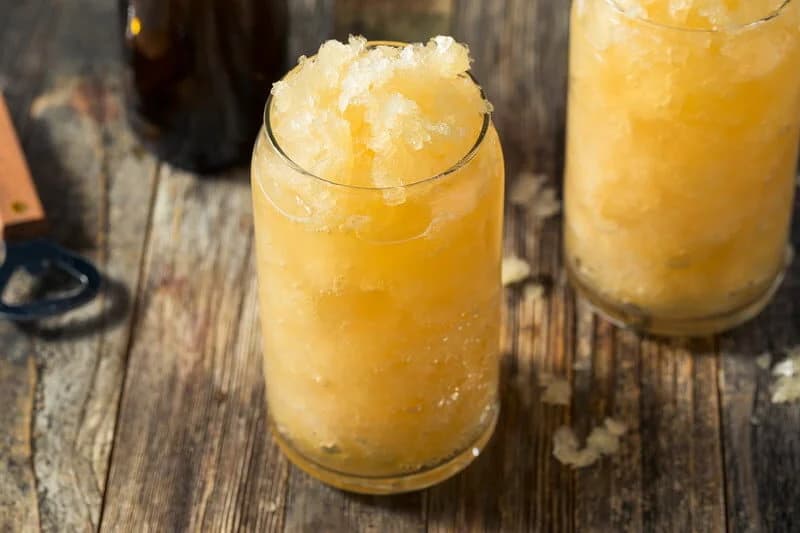 A frosty beer slushee in a can-shaped glass