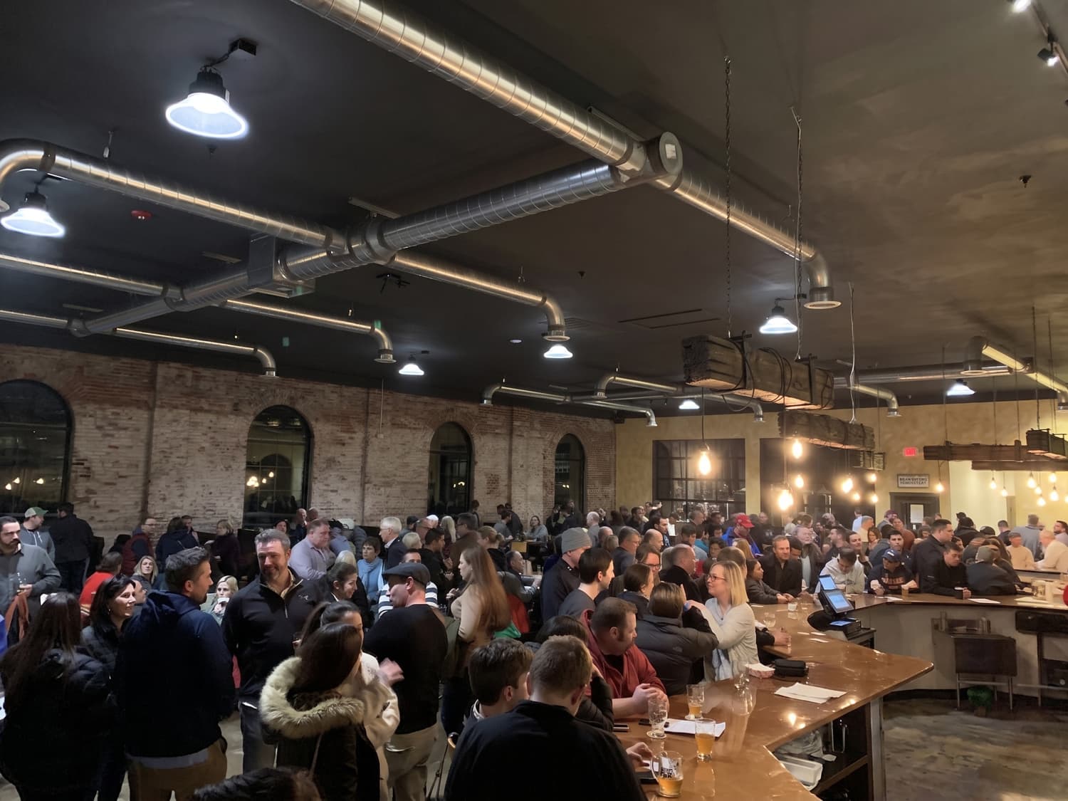 The Braeloch taproom full of guests under exposed-brick arches